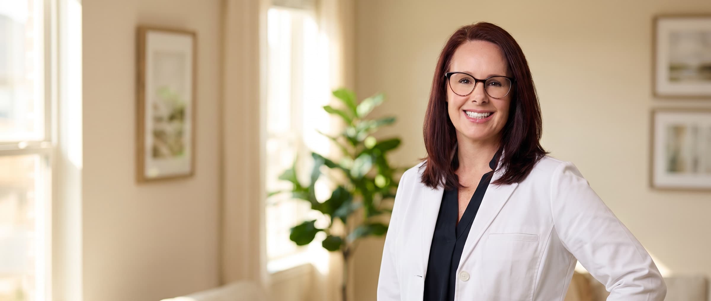 A Central Home Health nurse practitioner in a warm Houston home, a colleague behind her